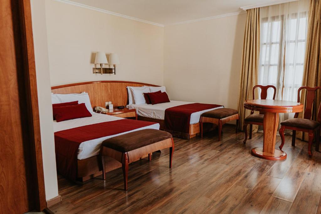 Postel nebo postele na pokoji v ubytování Gran Hotel Diligencias