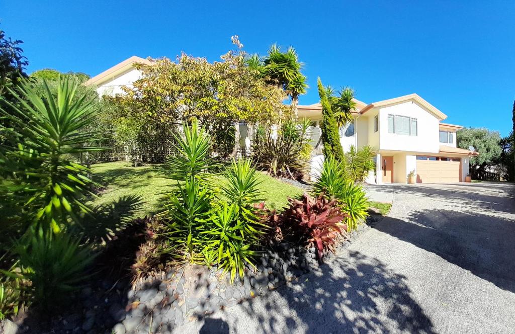 una casa con muchas plantas en la entrada en Seascape Villa B&B, en Tauranga