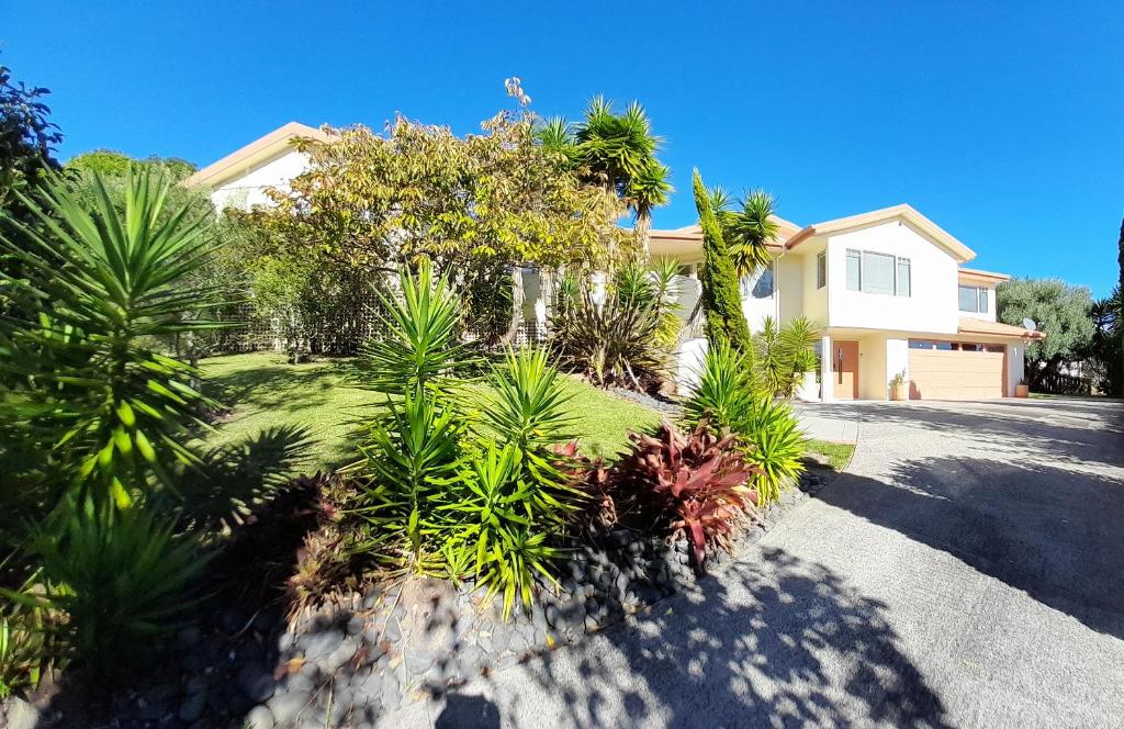 a house with a lot of plants in the driveway at Seascape Villa B&B in Tauranga