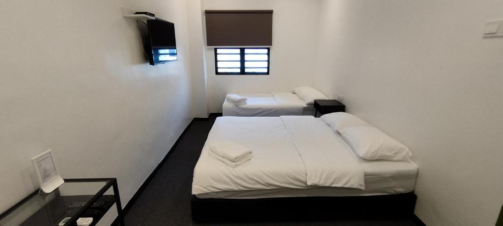 Postel nebo postele na pokoji v ubytování Olive Bedz Hotel