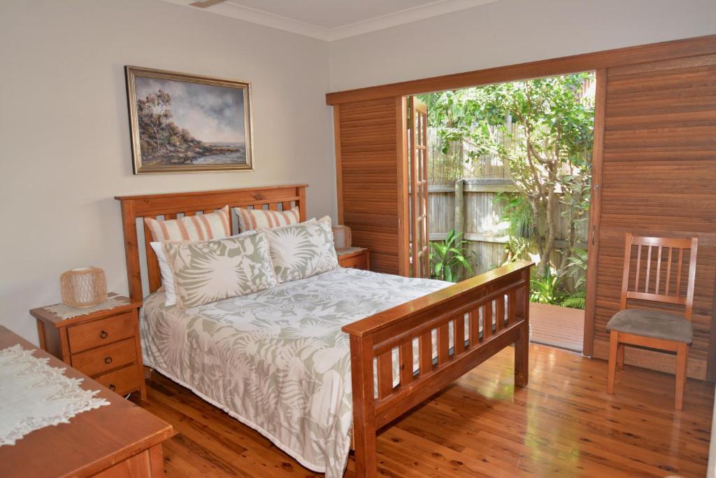 a bedroom with a bed and a sliding glass door at Do Not Book in Nelly Bay