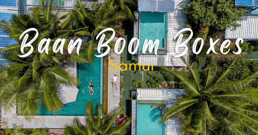 an overhead view of a swimming pool with palm trees at Baan Boom Boxes Eco Friendly Resort in Mae Nam