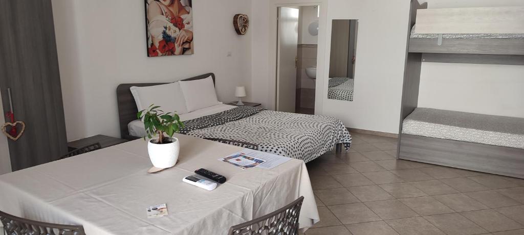 a bedroom with a bed and a table with a plant on it at La dimora di Roberto in Santeramo in Colle