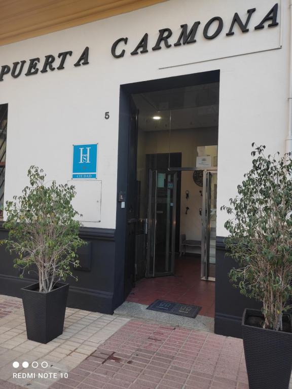 a entrance to a building with a sign on it at Hostal Puerta Carmona in Seville