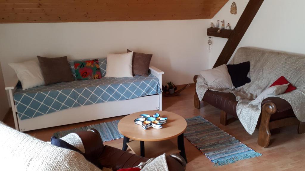 a living room with a bed and a table and chairs at Halte au pied du Creux du Van in Travers