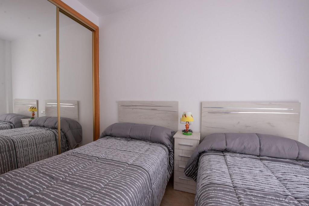 A bed or beds in a room at Holiday beach Gran Alacant