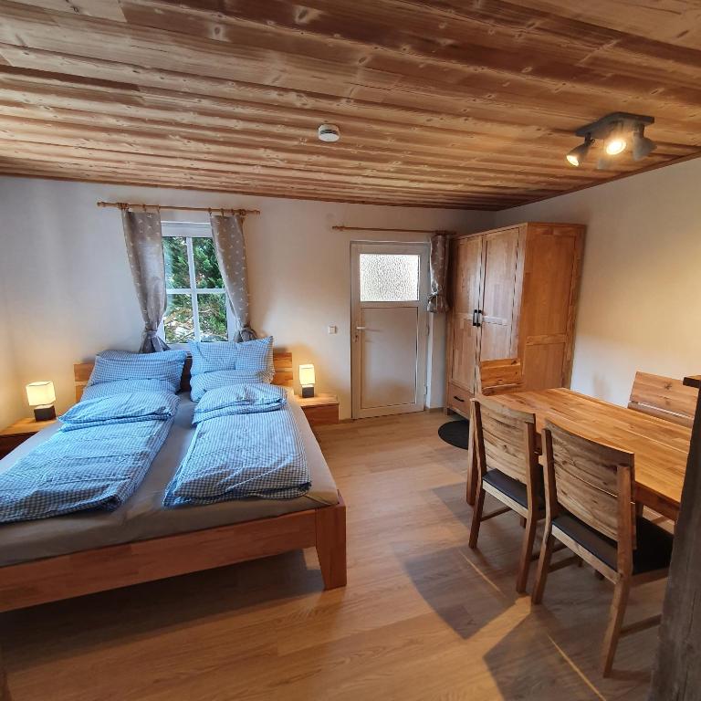 a bedroom with two beds and a wooden ceiling at Alte Backstube - Ferienwohnung Hüttenstube und Ferienzimmer Auszeit in Erkenbrechtsweiler