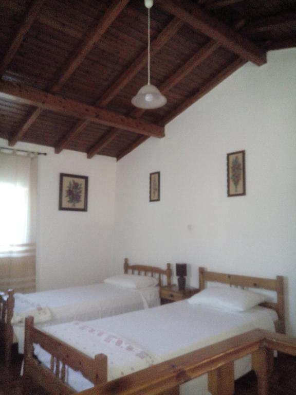 A bed or beds in a room at Traditional House with Loft -Michalis' House in Kouramades-