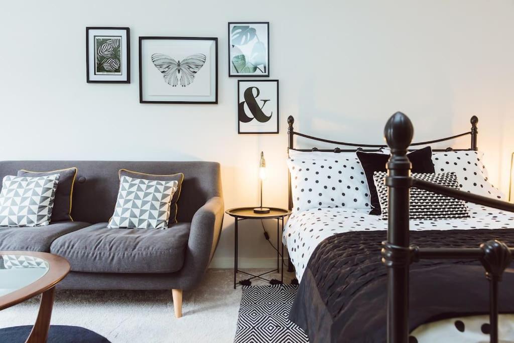 a bedroom with a bed and a couch at Cherry Tree Lodge in Anstey