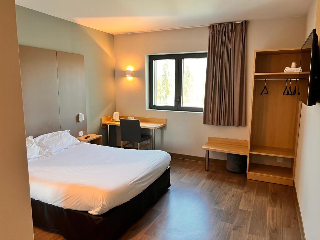 Postel nebo postele na pokoji v ubytování Campanile Metz Nord - Woippy- Porte du Luxembourg A31