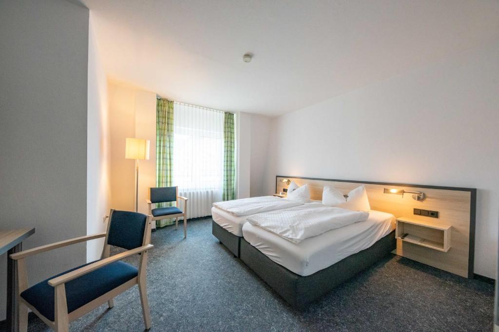 Postel nebo postele na pokoji v ubytování Hotel 7 Säulen GmbH
