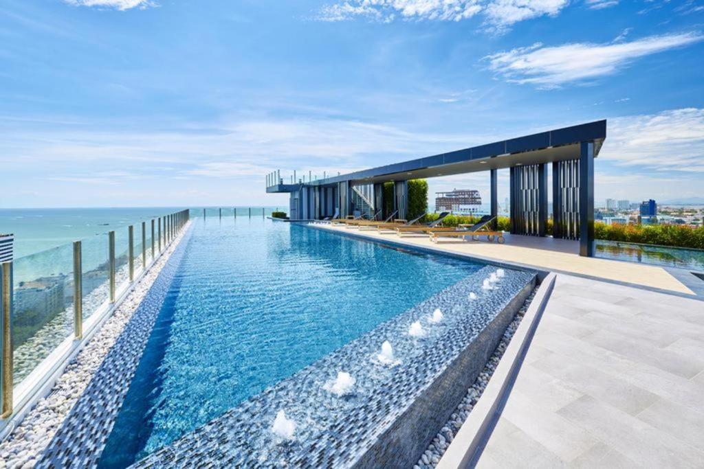 an infinity pool with the ocean in the background at The Base Infinity in Pattaya Central