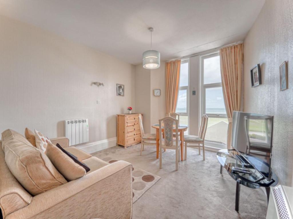a living room with a couch and a table at Apartment 2 - 1 Bedroom Sea Front-Sea Views-Free Parking in Paignton