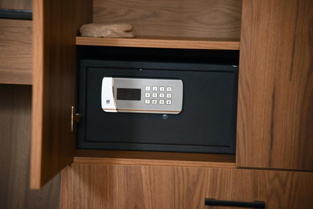 a small microwave in a wooden cabinet at Fener Motel in Şile