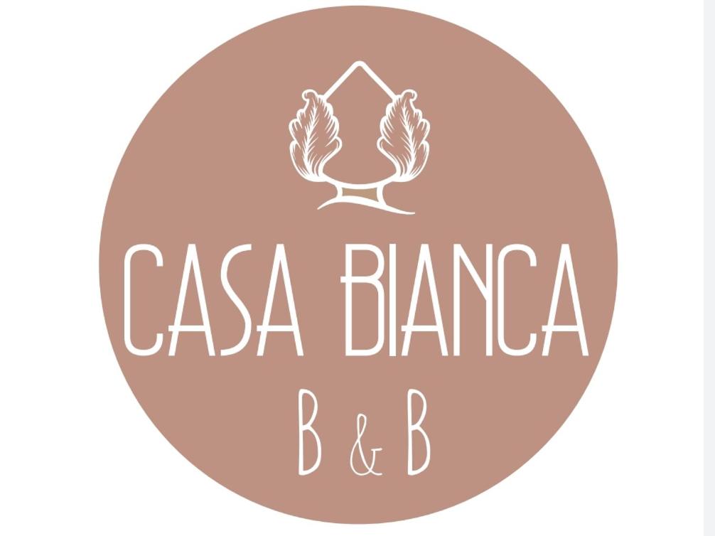 a pink circle with the words casa banca baranca and bc at Casa Bianca B&B in Ostuni