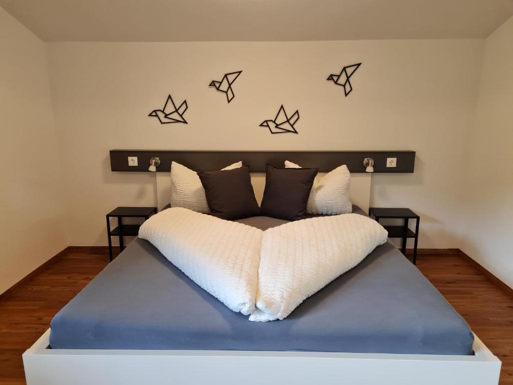 a bedroom with a bed with black and white pillows at Ferienwohnung Zauberwinkelweg mit Traum-Aussicht! in Wildschönau