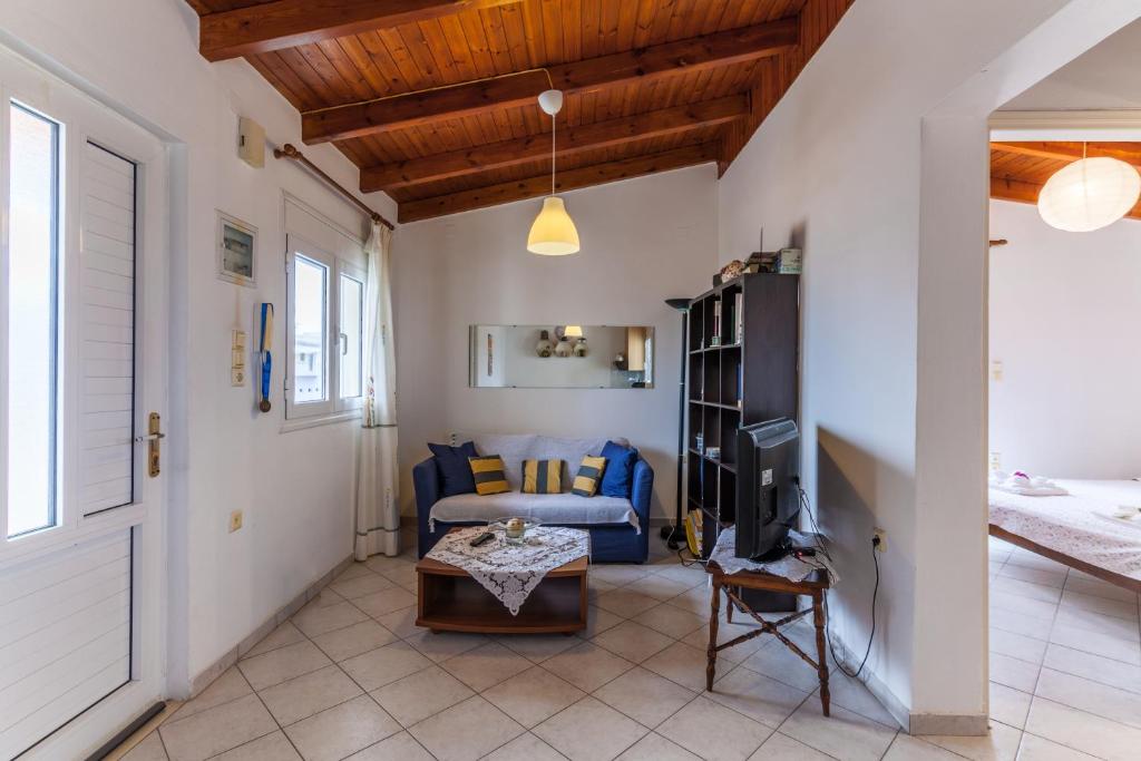 a living room with a couch and a table at Ioannis Appartment in Heraklio Town