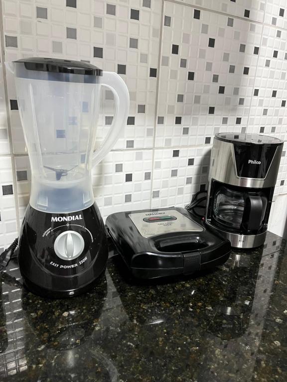 a blender and a coffee maker on a counter at Apartamento em Boa Vista in Boa Vista