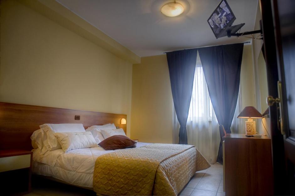 Postel nebo postele na pokoji v ubytování Hotel Tuscania Panoramico