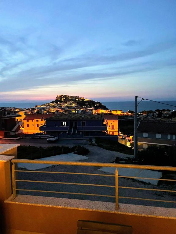 a view of a city with a hill in the distance at Appartamento Il Tramonto in Castelsardo