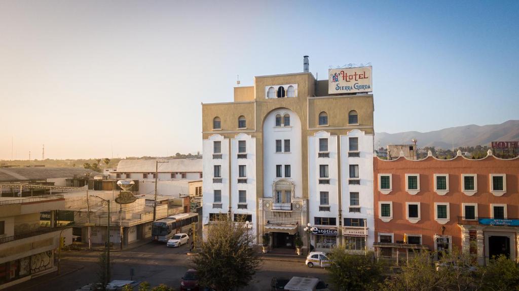 Un bâtiment blanc avec un panneau en haut dans l'établissement Hotel Sierra Gorda, à Ciudad Victoria