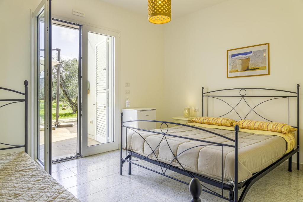 Łóżko lub łóżka w pokoju w obiekcie SalentOspita Guest Rooms