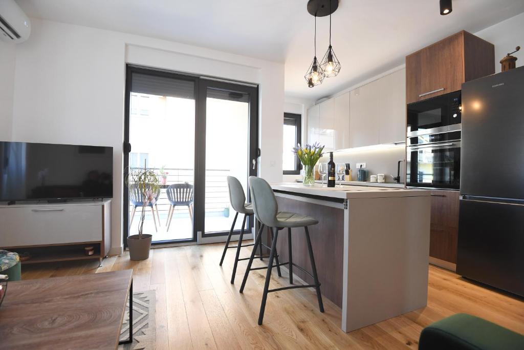 a kitchen with a island with stools and a counter top at Apartment Maritimo in Zadar