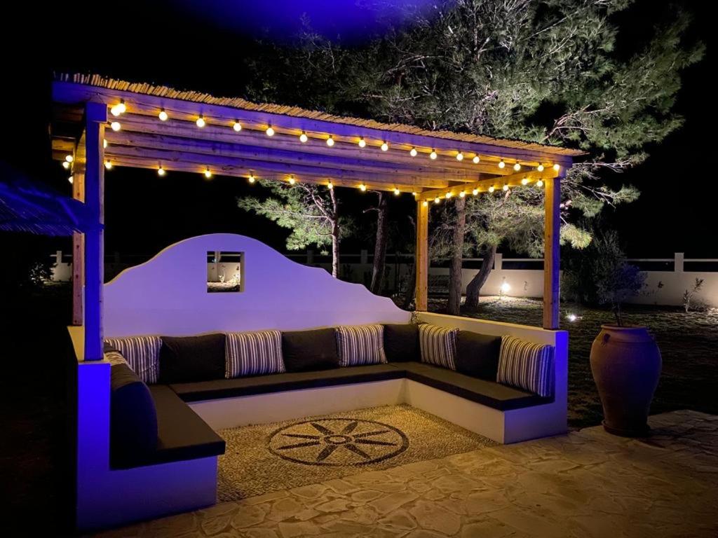 a couch sitting under a gazebo with lights at Villa Mamma Mia in Gennadi