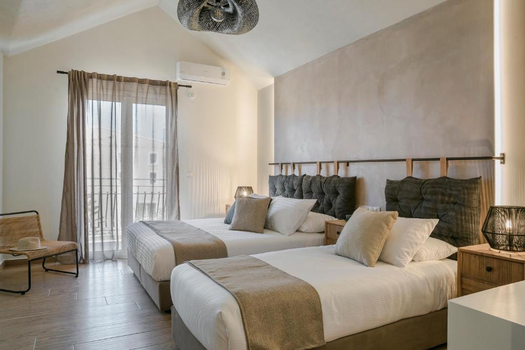 Postel nebo postele na pokoji v ubytování Socrates Apartments