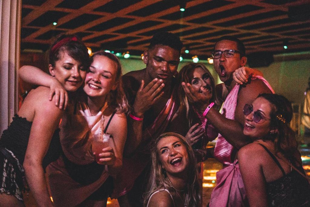a group of people posing for a picture at a party at The Pink Palace Hostel in Agios Gordios