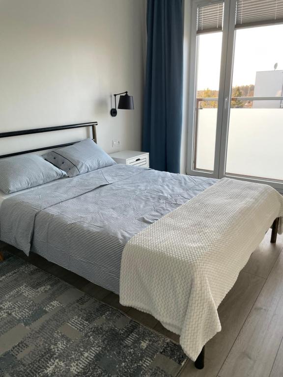 Posteľ alebo postele v izbe v ubytovaní Apartament Dziewiątka