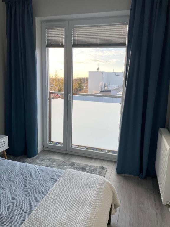 Posteľ alebo postele v izbe v ubytovaní Apartament Dziewiątka