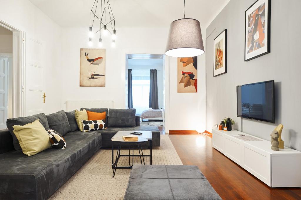 a living room with a couch and a tv at Irundo Downtown Apartments in Zagreb