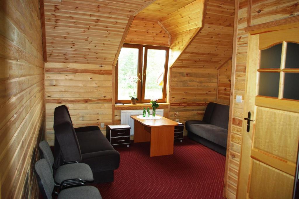 a room with two chairs and a table in a cabin at Malibu Lublin in Lublin