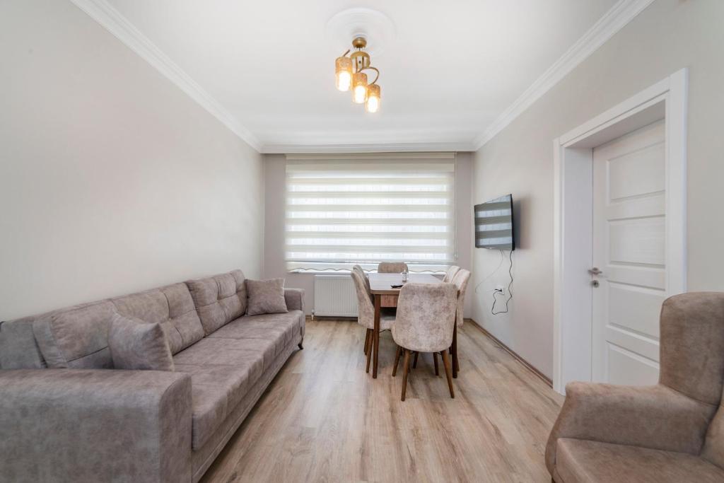 a living room with a couch and a table at Fresh apartment in authentic neighborhood in Bursa