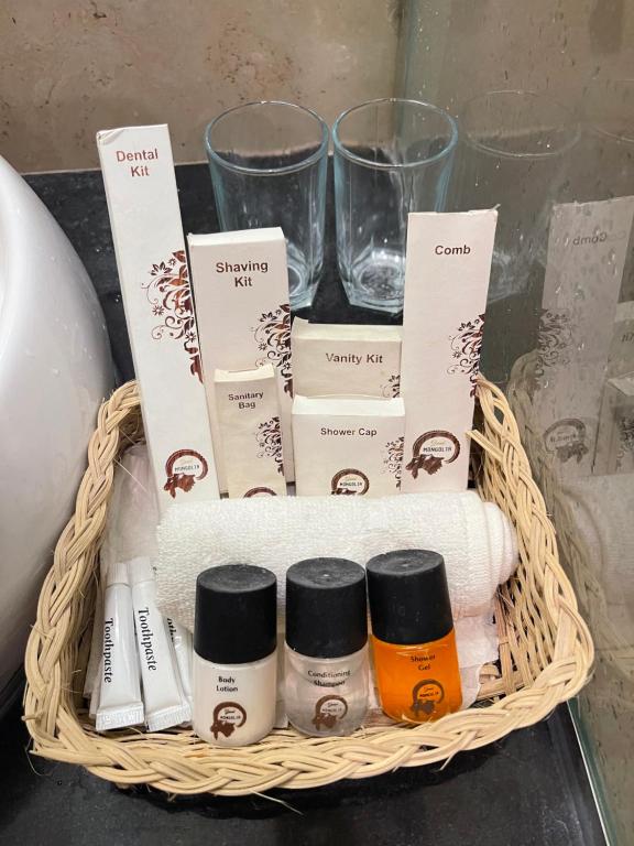 a basket with towels and other products on a table at Grand Mongolia Hotel in Rawalpindi