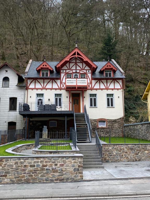 a large house with a red and white at Ferienhaus Endertsesel in Cochem