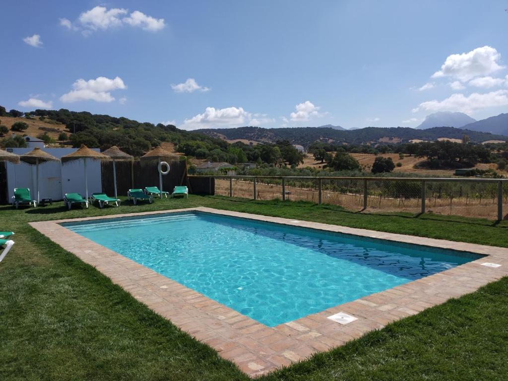 a swimming pool in the yard of a house at Rincón de Marco y María in Prado del Rey