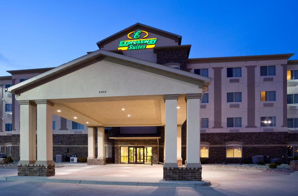 a hotel building with a sign on top of it at Expressway Suites Fargo in Fargo