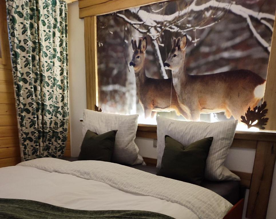 a bedroom with two deer statues on a window at Erholsame 2 Zimmer FeWo mit King-Size-Bett, Pool und Stellplatz in Baiersbronn