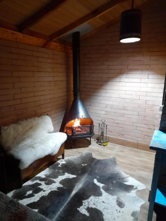 a room with a fireplace in a room with snow at Sossego do Interior III in Nova Petrópolis