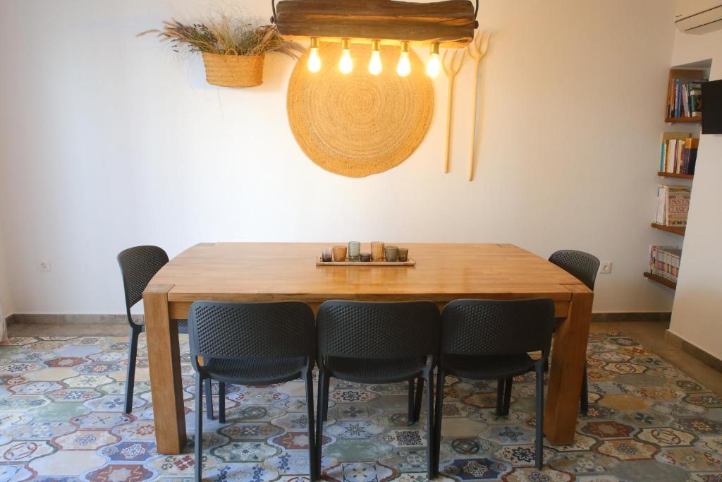 a dining room with a wooden table and chairs at Casa Sant Vicent 63 in Teulada