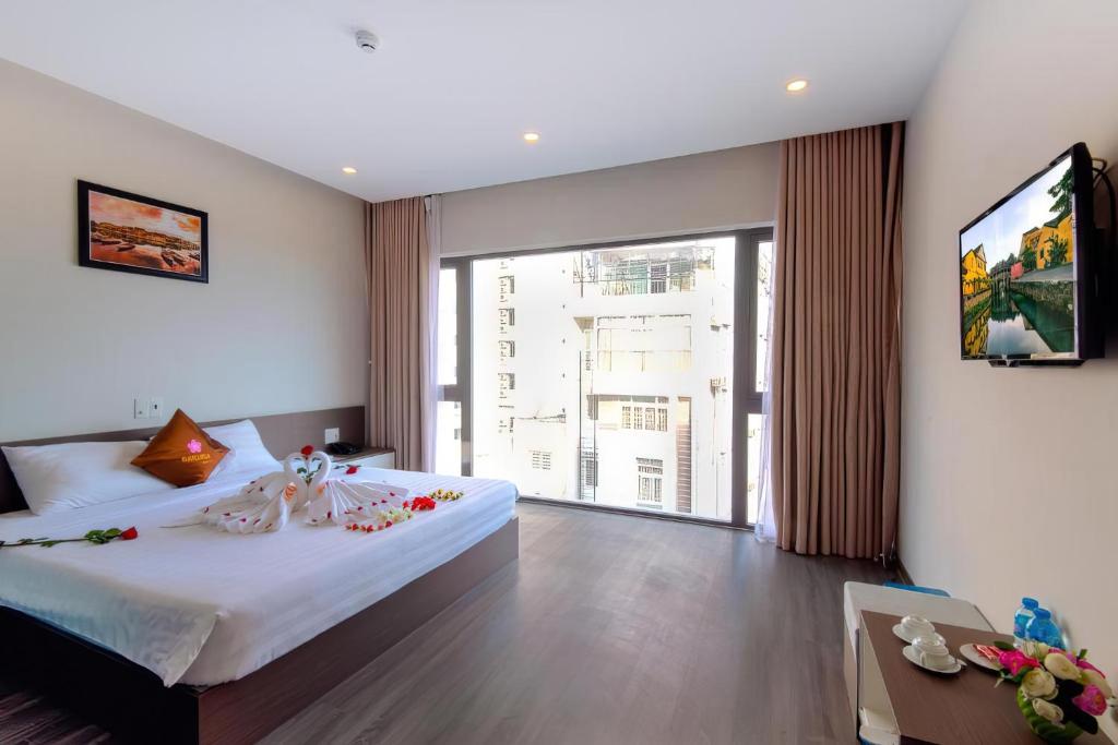 Postel nebo postele na pokoji v ubytování The Shann Hotel Danang