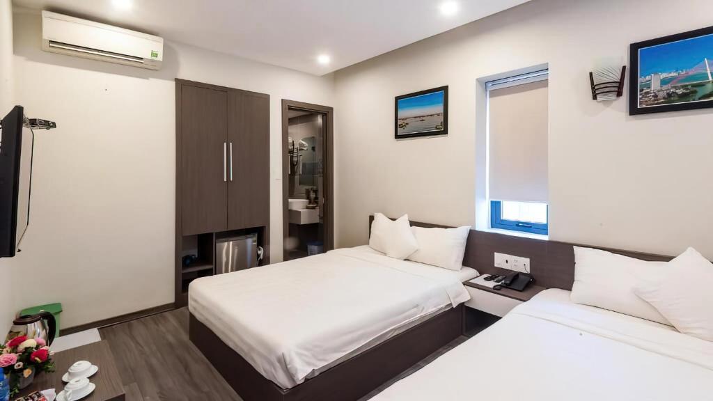 Postel nebo postele na pokoji v ubytování The Shann Hotel Danang