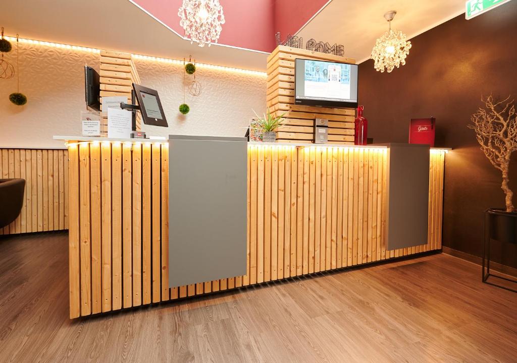 a lobby of a restaurant with a checkout counter at MY HOME Hotel Lamm Rottweil "Smart Home" in Rottweil