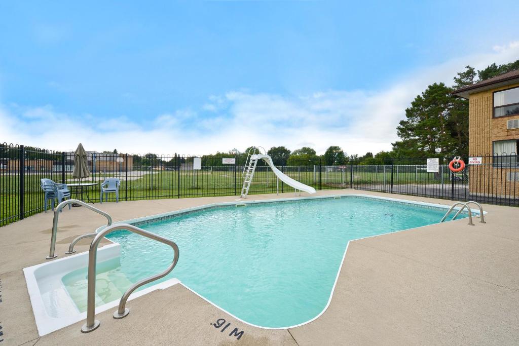 a swimming pool with a slide in a building at Angus Inn Motel in Angus