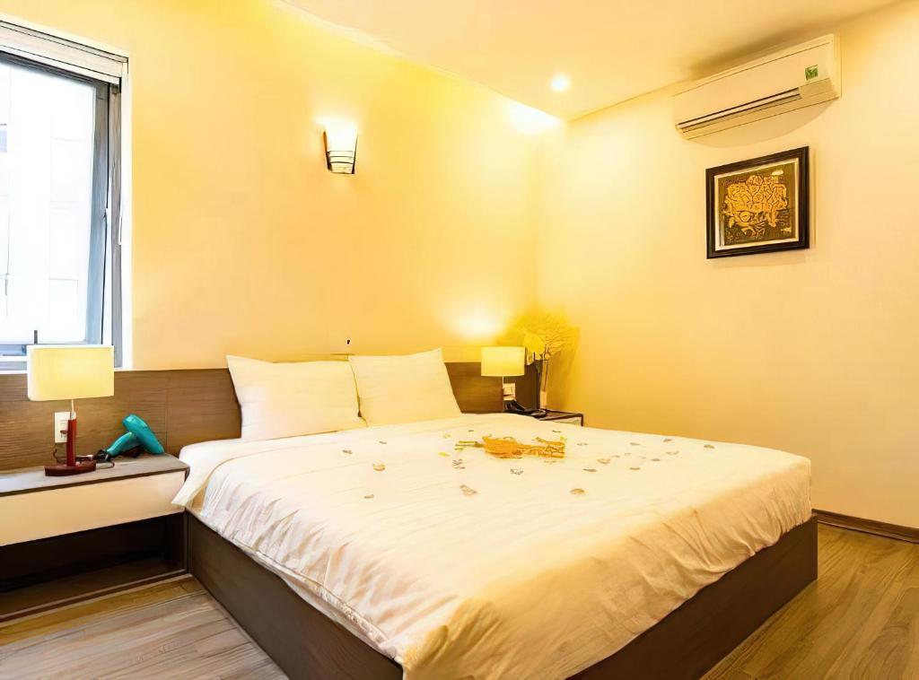 Postel nebo postele na pokoji v ubytování The Shann Hotel Danang