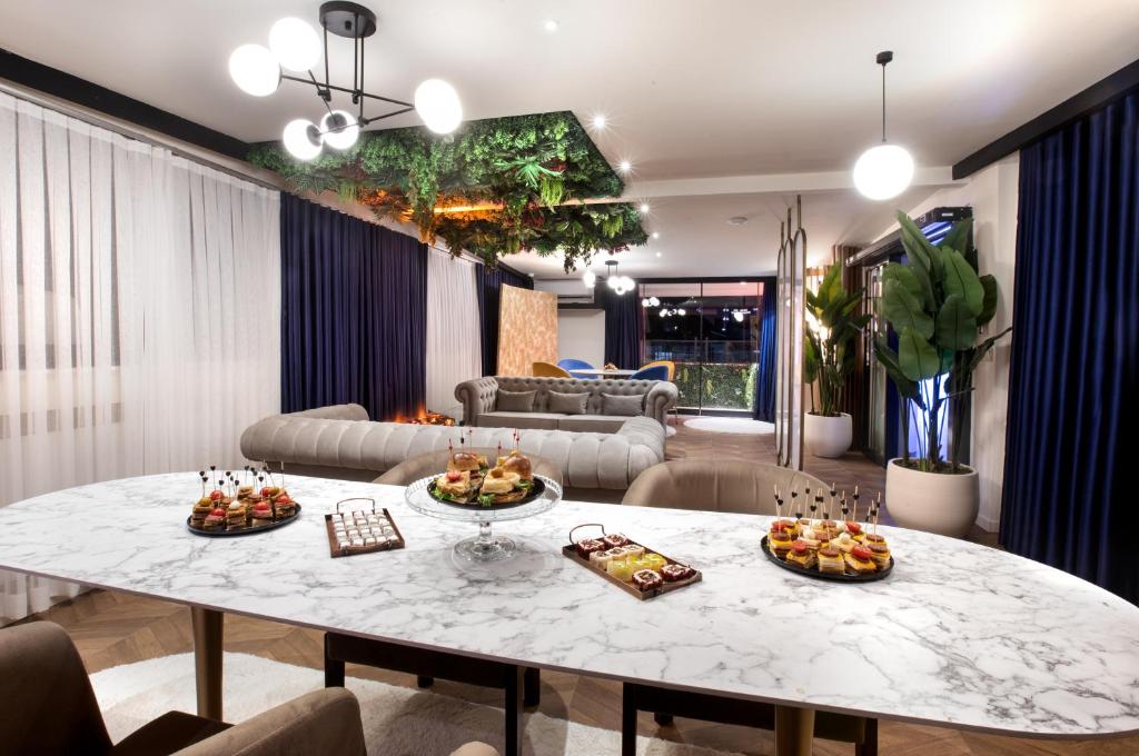 a living room with a table with food on it at Walton Gardens Pera in Istanbul