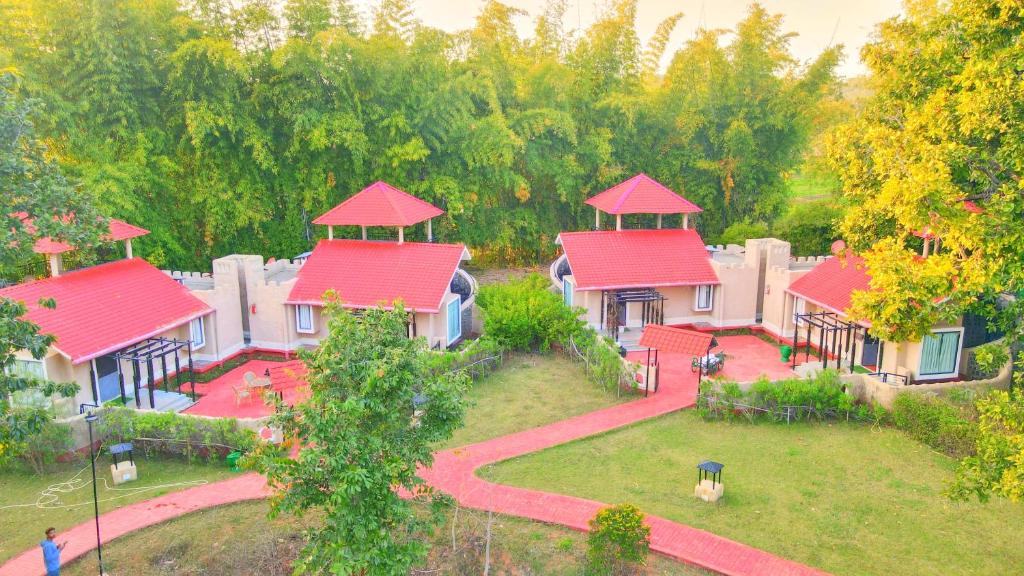 an overhead view of a group of houses with red roofs at Bundela Bandhavgarh by Octave in Mānpur