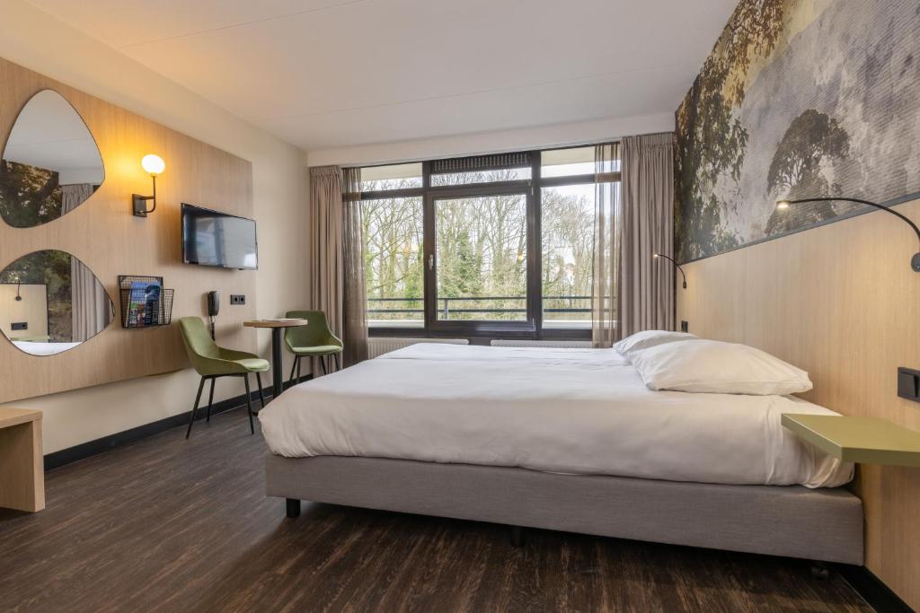 Postel nebo postele na pokoji v ubytování Fletcher Hotel-Restaurant Frerikshof
